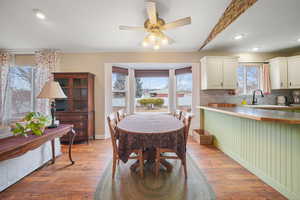 Dining space with light wood-style floors, recessed lighting, ceiling fan, and baseboards