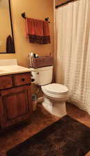 Bathroom featuring toilet, vanity, and tile patterned floors