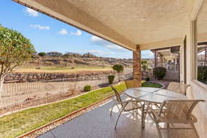 View of patio with outdoor dining space and a fenced backyard