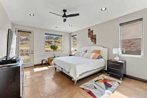 Bedroom with access to outside, multiple windows, and baseboards