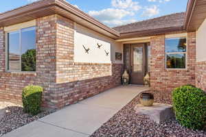 Entrance to property featuring brick siding and stucco siding