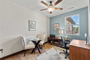 Office space featuring baseboards, visible vents, and a ceiling fan