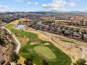 Drone / aerial view with golf course view, a residential view, and a water and mountain view