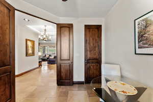 Interior space with recessed lighting, baseboards, a notable chandelier, and stone tile floors