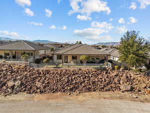 Single story home featuring stucco siding, a mountain view, and fence