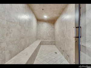 Full bath featuring a tile shower