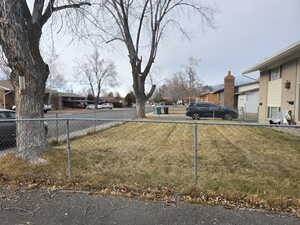 View of yard with a residential view and fence