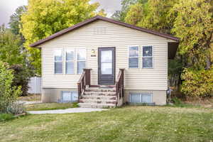 Bungalow-style house featuring a front yard