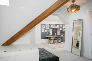 Office featuring baseboards, a chandelier, and light colored carpet