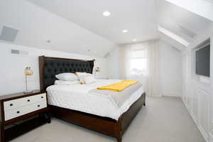 Bedroom with lofted ceiling, recessed lighting, visible vents, light carpet, and baseboards