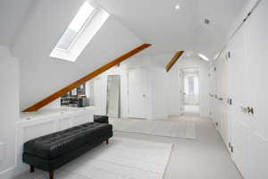 Sitting room with vaulted ceiling with skylight, visible vents, baseboards, light colored carpet, and recessed lighting