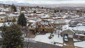 Snowy aerial view with a mountain view and a residential view