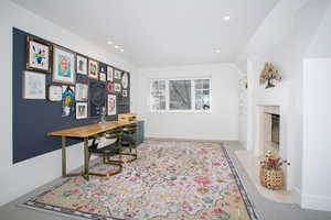 Office area featuring a high end fireplace, baseboards, and recessed lighting