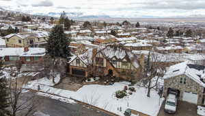 Snowy aerial view with a residential view and a mountain view