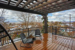 Snow covered deck with a pergola