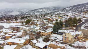 Snowy aerial view with a residential view and a mountain view