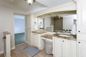 Full bathroom featuring baseboards, shower / bath combination, vanity, and tile patterned floors