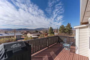 Wooden terrace with a residential view and a mountain view