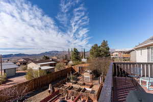 Exterior space with fence private yard, a residential view, a vegetable garden, and a mountain view