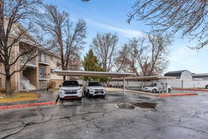 Partially covered parking lot featuring fence