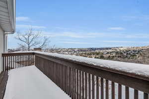 View of snow covered back of property