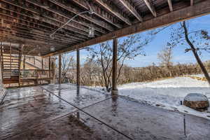 Yard covered in snow featuring stairs