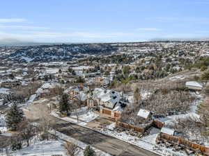 Snowy aerial view featuring a residential view and a mountain view