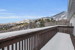 Snow covered back of property featuring a mountain view