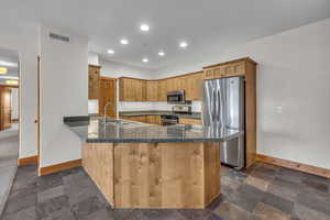 Kitchen with recessed lighting, stainless steel appliances, a peninsula, a sink, and visible vents