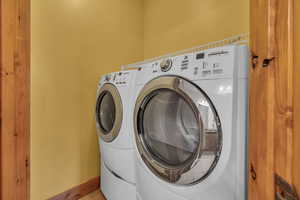 Laundry area featuring laundry area, baseboards, and separate washer and dryer