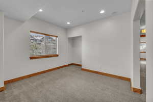 Carpeted spare room featuring recessed lighting, a healthy amount of sunlight, and baseboards