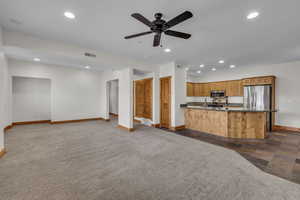 Unfurnished living room featuring baseboards, dark colored carpet, visible vents, and recessed lighting