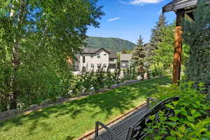 View of grassy yard featuring a mountain view