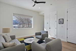 Living area with light wood-style floors, recessed lighting, baseboards, and a ceiling fan