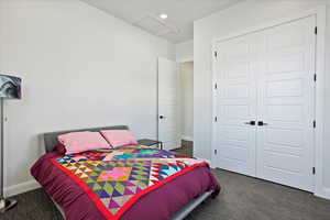 Bedroom featuring recessed lighting, baseboards, a closet, dark colored carpet, and attic access