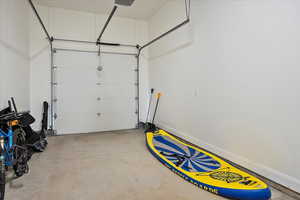 Garage featuring baseboards