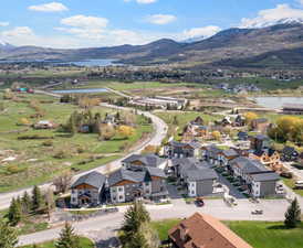 Drone / aerial view featuring a water and mountain view