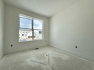 Spare room with a textured ceiling and baseboards