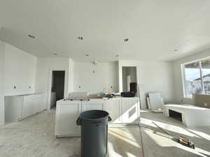 Kitchen featuring white cabinetry and a textured ceiling