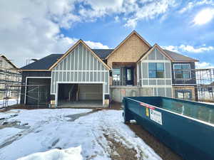 View of front of property with roof with shingles and an attached garage