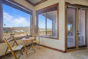 Interior space with baseboards, carpet floors, and crown molding