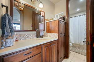 Full bath with toilet, vanity, and tile patterned floors