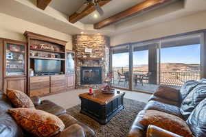 Living area with a wealth of natural light, beamed ceiling, and a mountain view