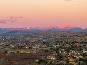 Property view of mountains with a residential view