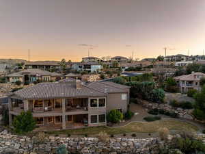 Rear view of house with a patio, a tile roof, a residential view, a chimney, and stucco siding