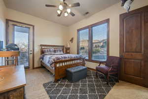 Bedroom featuring multiple windows, carpet flooring, visible vents, and baseboards