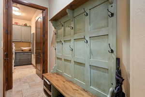 Mudroom with stone tile floors