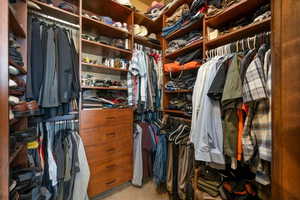 Spacious closet featuring light colored carpet