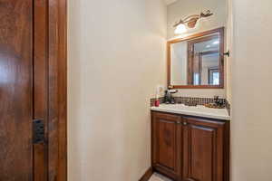 Bathroom with a textured wall and vanity