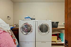 Washroom featuring a sink and washing machine and clothes dryer